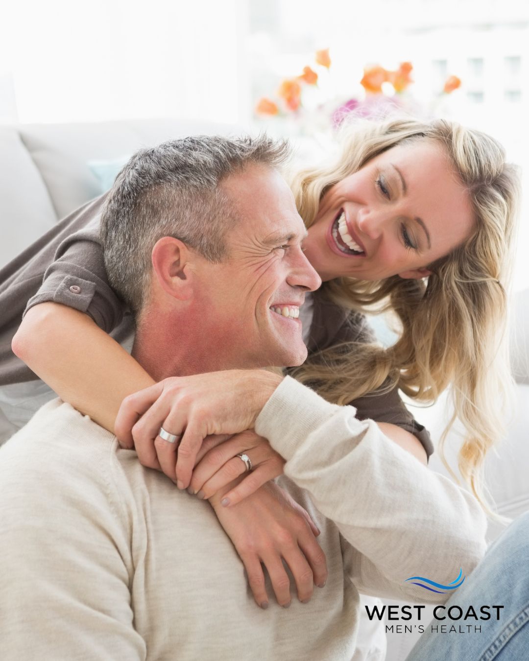 husband and wife holding each other and laughing